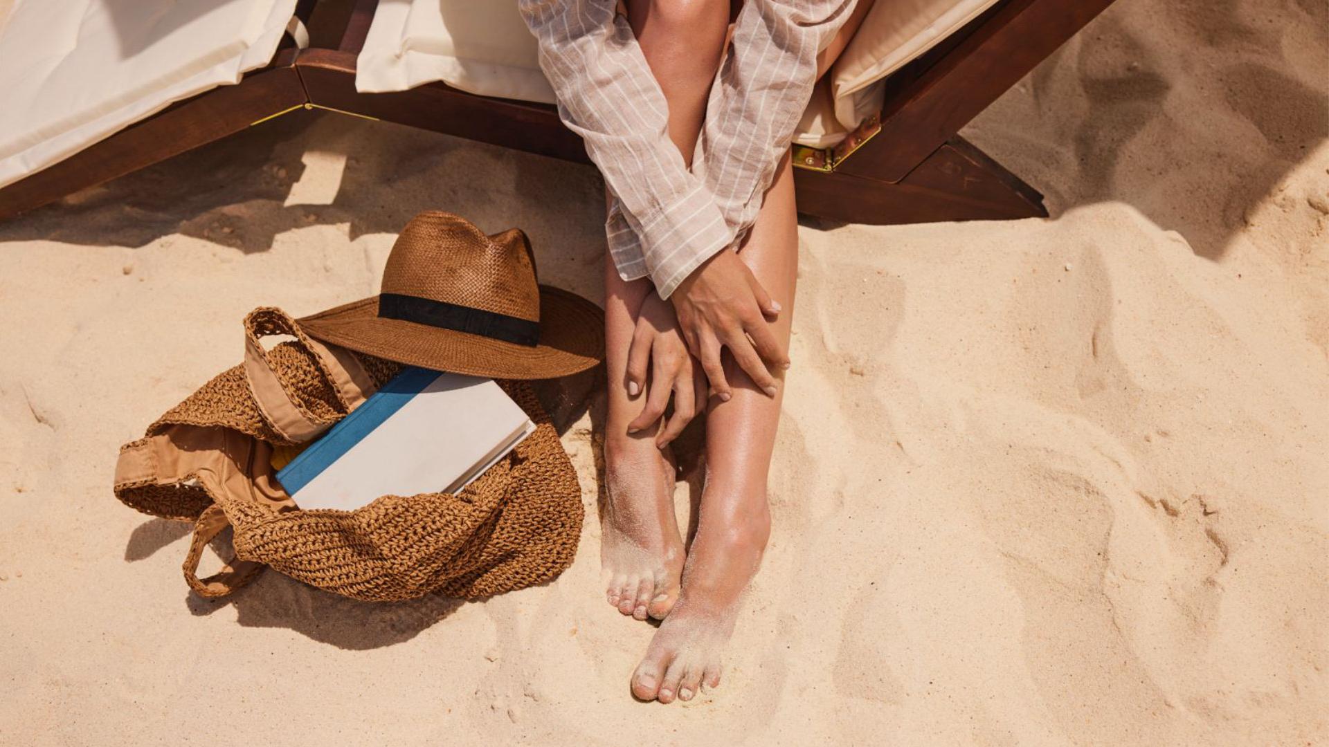 Foto dos pés de uma turista na areia da praia em Aruba